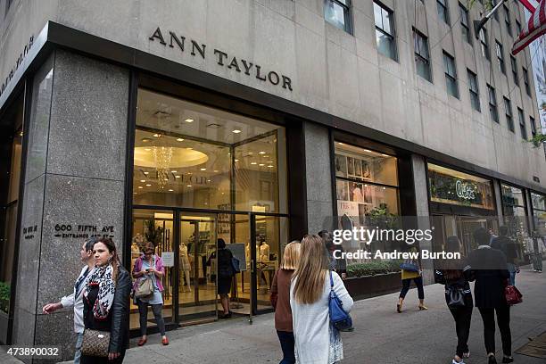 People pass the window display of an Ann Taylor women's clothing store in Manhattan on May 18, 2015 in New York City. Ascena Retail Group which owns...