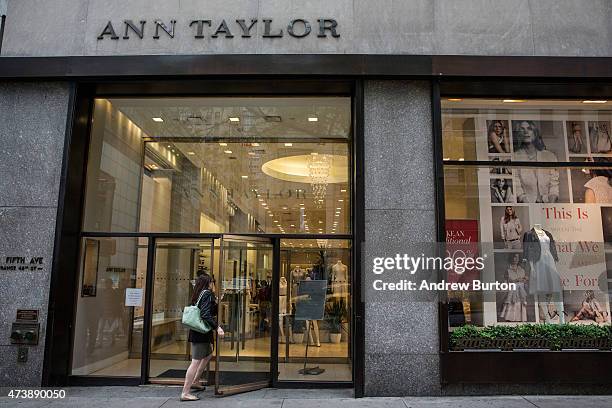 People pass the window display of an Ann Taylor women's clothing store in Manhattan on May 18, 2015 in New York City. Ascena Retail Group which owns...