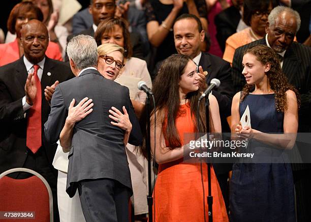 Chicago Mayor Rahm Emanuel hugs his wife Amy Rule as he stands on stage with daughters Leah and Ilana after taking the oath of office as he is...