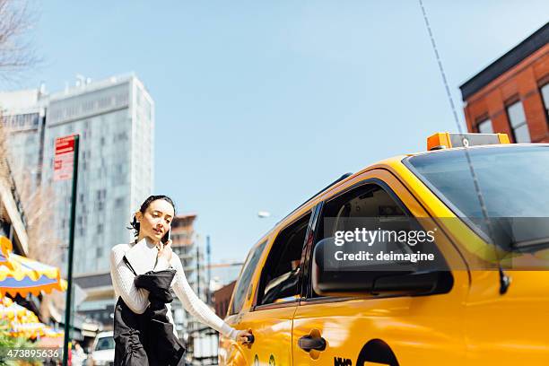 busy business woman on the phone while taking a taxi - businesswoman nyc stock pictures, royalty-free photos & images