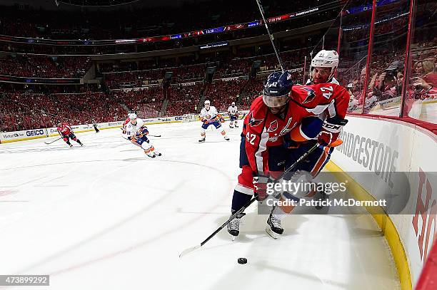 Joel Ward of the Washington Capitals and John Tavares of the New York Islanders battle for the puck during the first period in Game Seven of the...