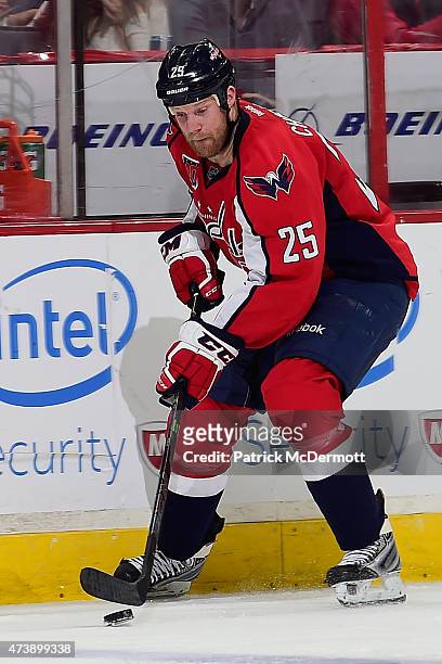 Jason Chimera of the Washington Capitals controls the puck against the New York Islanders during the second period in Game Seven of the Eastern...