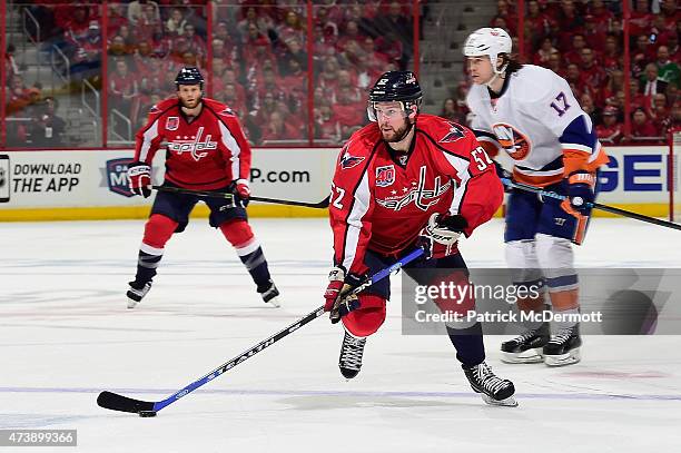 Mike Green of the Washington Capitals controls the puck against the New York Islanders during the second period in Game Seven of the Eastern...