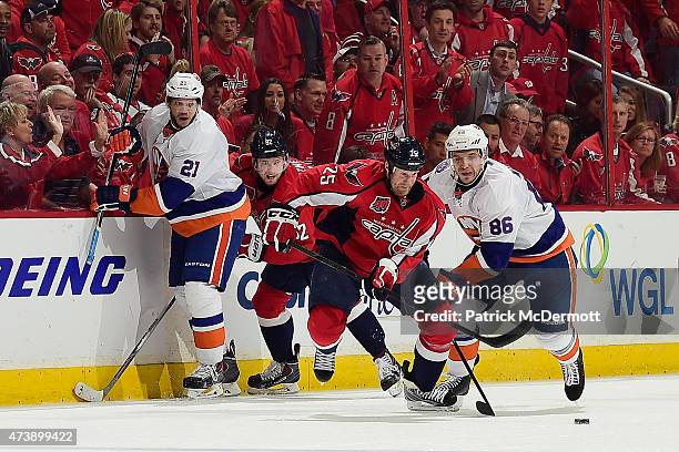 Jason Chimera of the Washington Capitals and Nikolay Kulemin of the New York Islanders battle for the puck during the second period in Game Seven of...