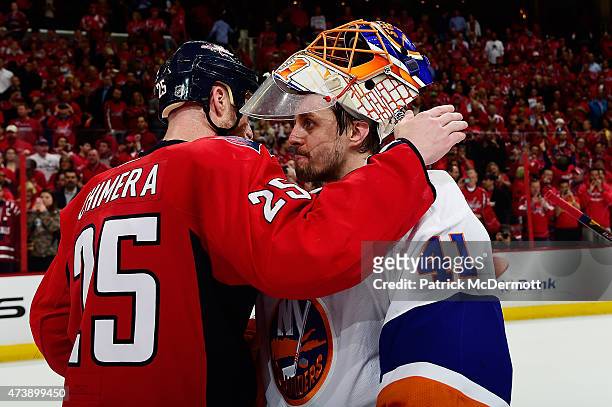Jason Chimera of the Washington Capitals and Jaroslav Halak of the New York Islanders shake hands following the Capitals victory over the Islanders...