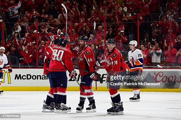Evgeny Kuznetsov of the Washington Capitals celebrates with his teammates afer scoring the game winning goal in the third period against the New York...