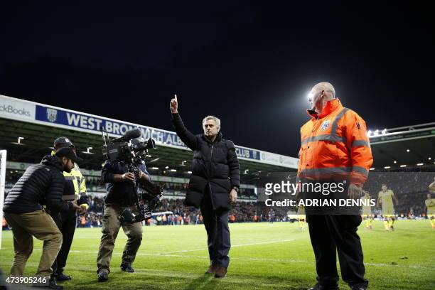 Chelsea's Portuguese manager Jose Mourinho gestures to the fans after the final whistle during the English Premier League football match between West...