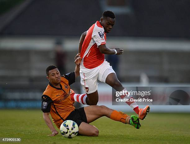 Marc Bola of Arsenal rides the challenge from Aaron Simpson of Wolves during the match between Arsenal U21s and Wolverhampton Wanderers U21s at...