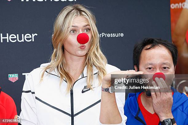 Russian tennis player Maria Sharapova and former American tennis player Michael Chang pose with a red nose to support the Association Theodora fund...