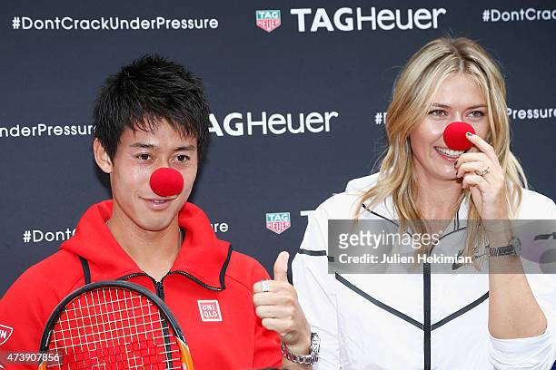Japanese tennis player Kei Nishikori and Russian tennis player Maria Sharapova pose with a red nose to support the Association Theodora fund event...