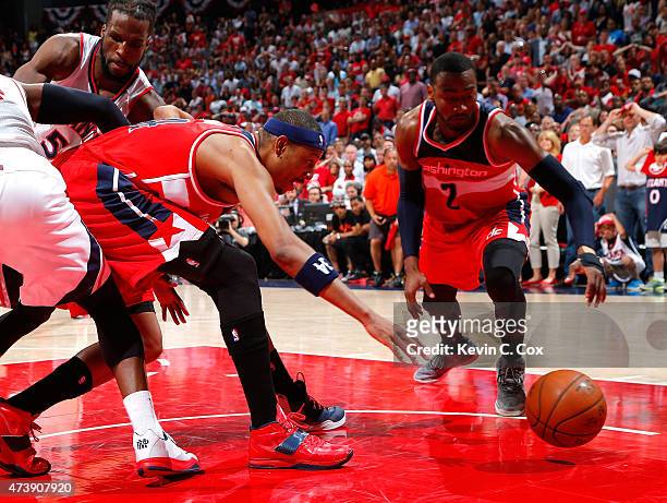 Paul Pierce of the Washington Wizards loses the ball against Paul Millsap and DeMarre Carroll of the Atlanta Hawks during Game Five of the Eastern...