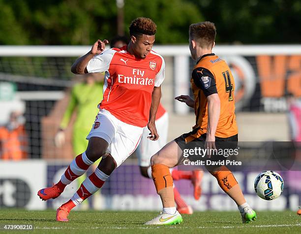 Serge Gnabry of Arsenal knocks the ball past Declan Weeks of Wolves during the match between Arsenal U21s and Wolverhampton Wanderers U21s at Meadow...