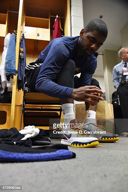 Kyrie Irving of the Cleveland Cavaliers ties his shoes in the locker room before a game against the Chicago Bulls in Game Six of the Eastern...