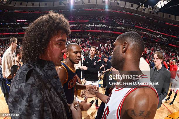Anderson Varejao and James Jones of the Cleveland Cavaliers shake hands with Nazr Mohammed of the Chicago Bulls after Game Six of the Eastern...