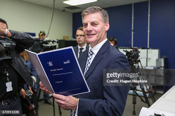 Finance Minister Bill English poses with a copy of his budget speech during the printing of the budget at Printlink on May 19, 2015 in Wellington,...