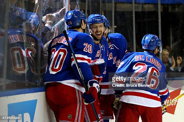 Derek Stepan of the New York Rangers celebrates with his teammates after scoring a goal in the second period against Ben Bishop of the Tampa Bay...