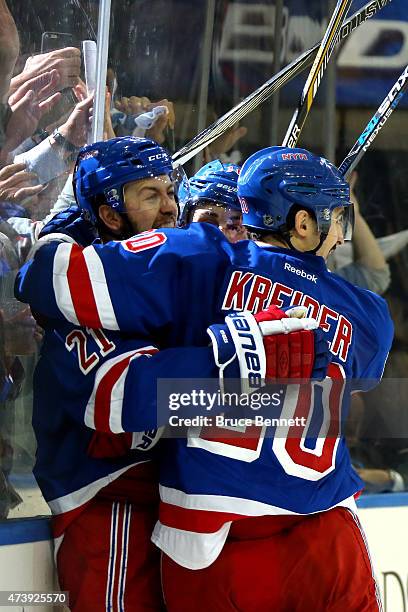 Derek Stepan of the New York Rangers celebrates with his teammates after scoring a goal in the second period against Ben Bishop of the Tampa Bay...