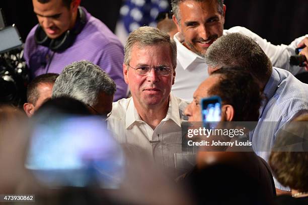 Former Florida Governor and potential Republican presidential candidate Jeb Bush greets people as he attends a fundraising event at the Jorge Mas...