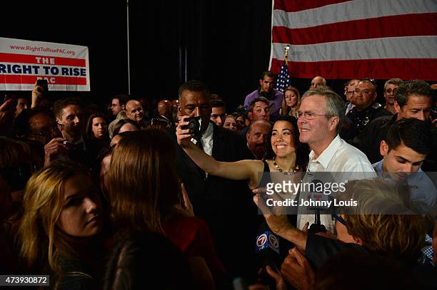 Former Florida Governor and potential Republican presidential candidate Jeb Bush greets people as he attends a fundraising event at the Jorge Mas...
