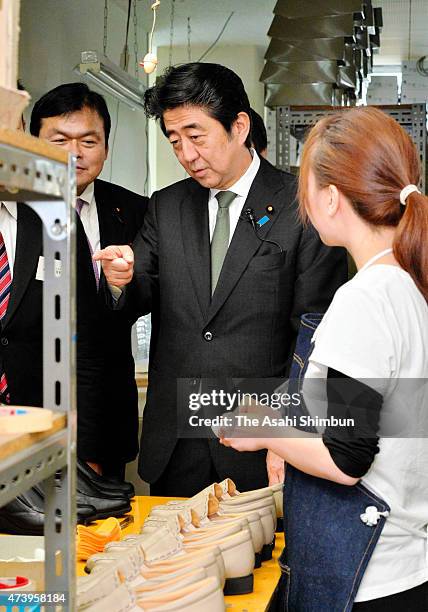 Japanese Prime Minister Shinzo Abe is seen during his visit to a shoe factory on May 16, 2015 in Kobe, Hyogo, Japan. Abe is two days inspection tour...