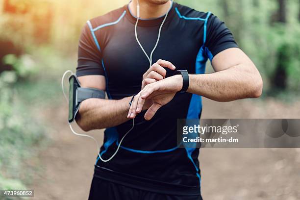 runner in the park preparing for jogging - checking sports stock pictures, royalty-free photos & images