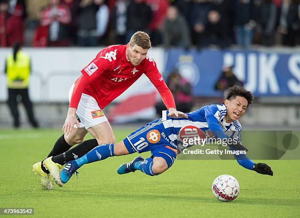 Atomu Tanaka of HJK Helsinki is tackled by Tuomas Aho of HIFK Helsinki during the Finnish First Division match between HJK Helsinki and HIFK Helsinki...