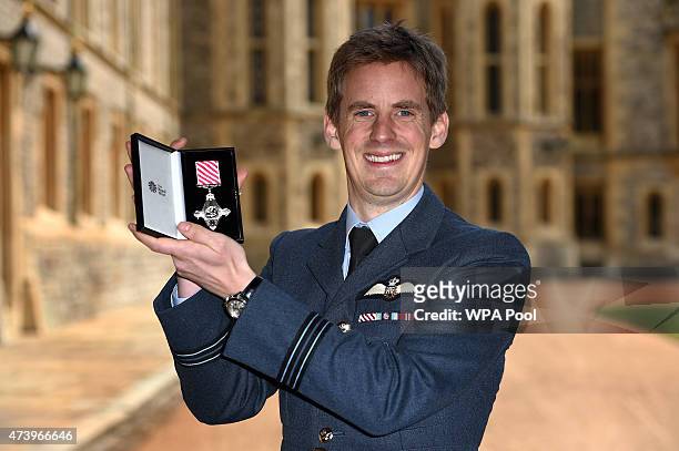 Flight Lieutenant Edward Berwick of the Royal Air Force with his Air Force Cross for great courage in the air at an investiture ceremony at Windsor...