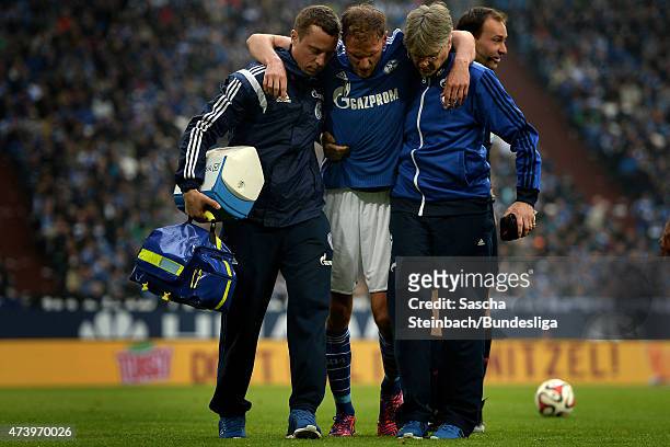 Benedikt Hoewedes of Schalke leaves the pitch after picking up an injury during the Bundesliga match between FC Schalke 04 and SC Paderborn on May...
