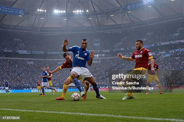 Eric Maxim Choupo-Moting is challenged by Marvin Bakalorz and Sueleyman Coc of Paderborn during the Bundesliga match between FC Schalke 04 and SC...