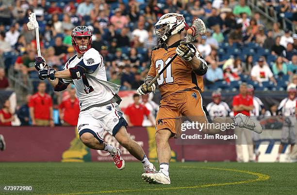 John Ranagan of the Rochester Rattlers runs by Scott McWilliams of the Boston Cannons at Gillette Stadium on May 17, 2015 in Foxboro, Massachusetts.