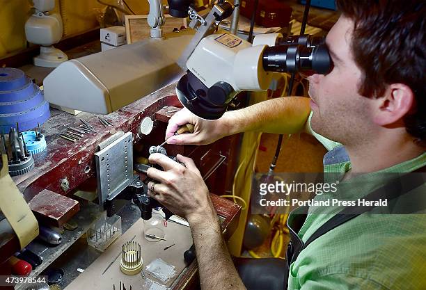 On The Job Feature. Ryan Cole, a jeweler at D Cole Jewelers on Exchange Street, uses a stereo microscope to do very fine adjusting to a diamond ring...