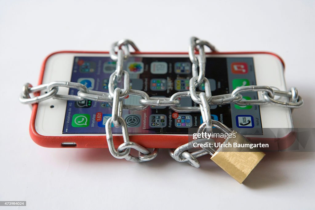 Security in the mobile network. Smartphone with chain and chain lock,