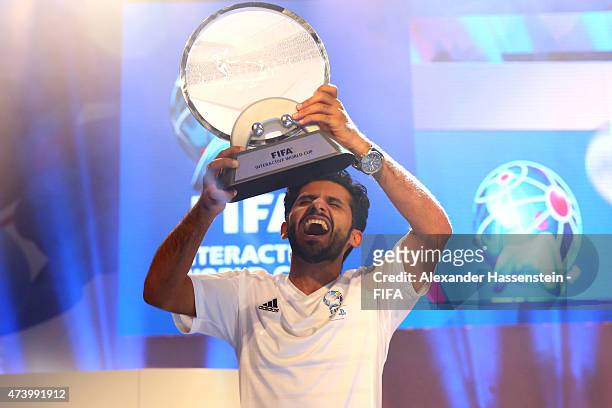 Abdulaziz Alshehri of Saudi Arabia celebrates with the FIFA Interactive World Cup winners trophy after winning his finale match against Julien...