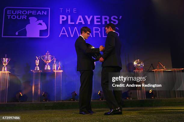 Brooks Koepka of the USA receives the Rookie of the Year award from Peter Uihlein of the USA during the European Tour Players' Awards ahead of the...