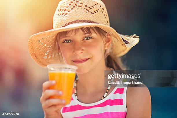 little tourist drinking a glass of fresh orange juice - orange hat stock pictures, royalty-free photos & images