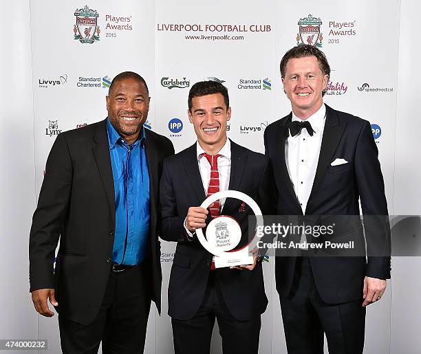 Philippe Coutinho of Liverpool poses for a photograph with John Barnes and Steve Mcmanaman after winning player of the year award during the...