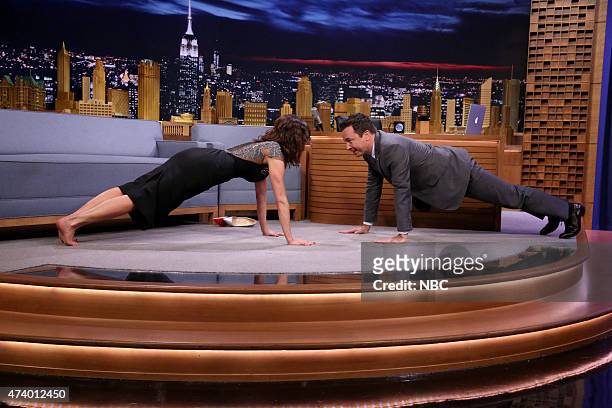 Episode 0266 -- Pictured: Actress Carla Gugino does pushups with host Jimmy Fallon on May 19, 2015 --