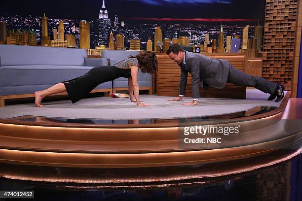 Episode 0266 -- Pictured: Actress Carla Gugino does pushups with host Jimmy Fallon on May 19, 2015 --