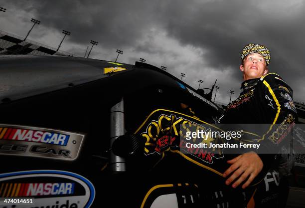Dylan Kwasniewski, driver of the Rockstar/FOE Chevrolet, climbs from his car during qualifying for the NASCAR Nationwide Series DRIVE4COPD 300 at...