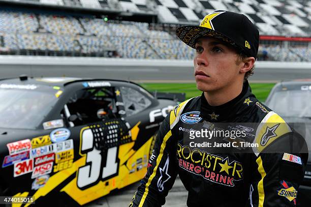 Dylan Kwasniewski, driver of the Rockstar/FOE Chevrolet, stands on the grid during qualifying for the NASCAR Nationwide Series DRIVE4COPD 300 at...