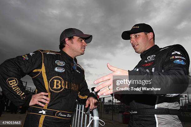 Jason White, driver of the Police Sunglasses/Friday Night Tykes Toyota, talks to Johnny Sauter, driver of the Goodyear Toyota, during qualifying for...