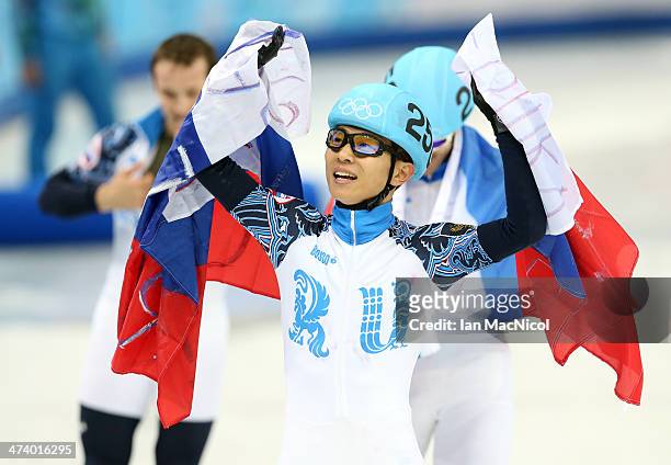 Victor An of Russia celebrates leading his team to victory in the 5000m Speed Skating relay on day fourteen of the 2014 Winter Olympics at the...