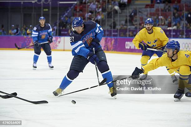 Winter Olympics: Finland Petri Kontiola in actionvs Sweden Nikla Hjalmarsson and Marcus Johansson during Men's Playoffs Semifinals at Bolshoy Ice...