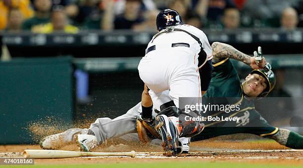 Brett Lawrie of the Oakland Athletics is tagged out by Jason Castro of the Houston Astros trying to score in the second inning at Minute Maid Park on...