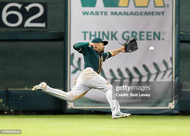 Coco Crisp of the Oakland Athletics can't track down this line drive off the bat of Colby Rasmus of the Houston Astros in the second inning at Minute...