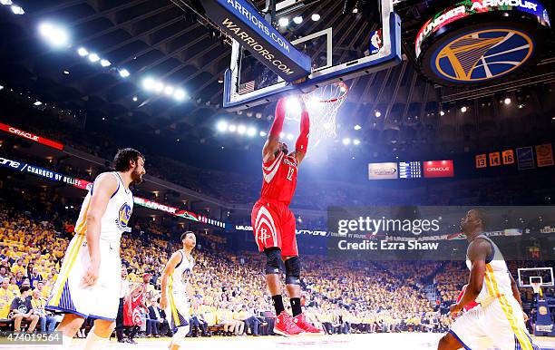 Dwight Howard of the Houston Rockets dunks on Harrison Barnes of the Golden State Warriors in the first quarter during Game One of the Western...