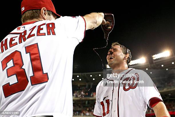 Ryan Zimmerman of the Washington Nationals has chocolate sauce dumped on him by teammate Max Scherzer after hitting a two run walk-off home run in...