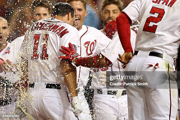 Ryan Zimmerman of the Washington Nationals is greeted at home plate after hitting a two run walk-off home run in the tenth inning against the New...