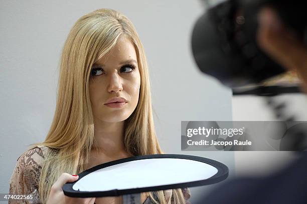 Model Georgia May Jagger prepares backstage ahead of the Versace Fashion Show during Milan Fashion Week Womenswear Autumn/Winter 2014 on February 21,...