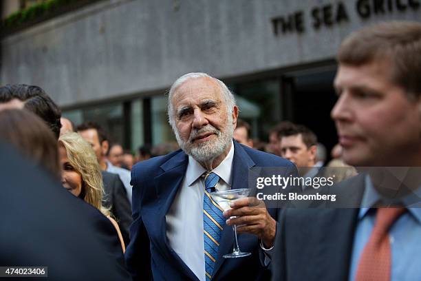 Billionaire activist investor Carl Icahn holds a martini glass while attending the Leveraged Finance Fights Melanoma charity event in New York, U.S.,...